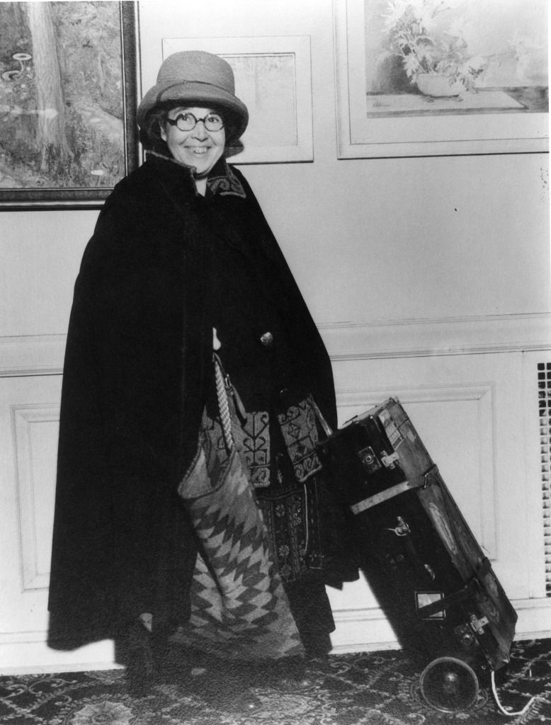 Anita-publicity-shot-with-suitcase-and-cape-227x300 (1).jpg